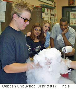 Picture of a student holding a beaker with dry ice (frozen carbon dioxide).
