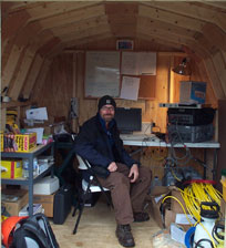  [Photo: USGS scientist operating computer equipment at field site.] 