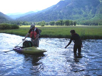  [Figure 4 - Photo: Scientists in creek with kayak.]  