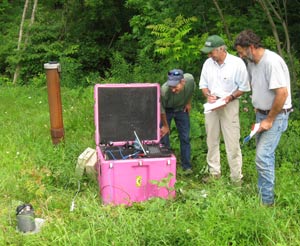  [Photo: USGS scientists operate laptop at field site.] 