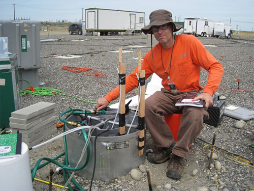  [Photo: scientist operating equipment in the field] 
