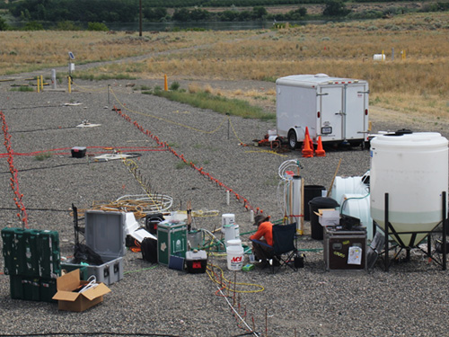  [Photo: View of field site and scientists working at Hanford 300 Area] 