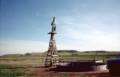 Photo showing wind-powered well and livestock watering tank in Platte County, Wyoming