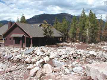 Photograph of building and surrounding area after 
   the mudslide on August 4, 2002.