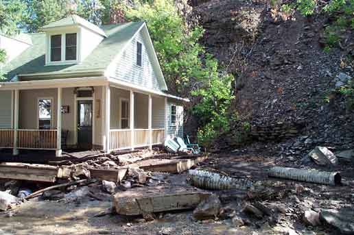 Photograph of building and surrounding area after 
   the mudslide on August 8, 2002.