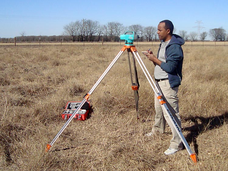 A doctoral student, supported by the Texas Water Resources Institute, takes notes during a field survey.