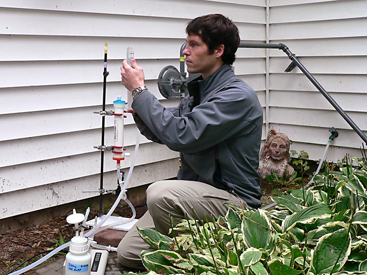 A researcher working with the Wisconsin Water Resources Institute takes well water samples.