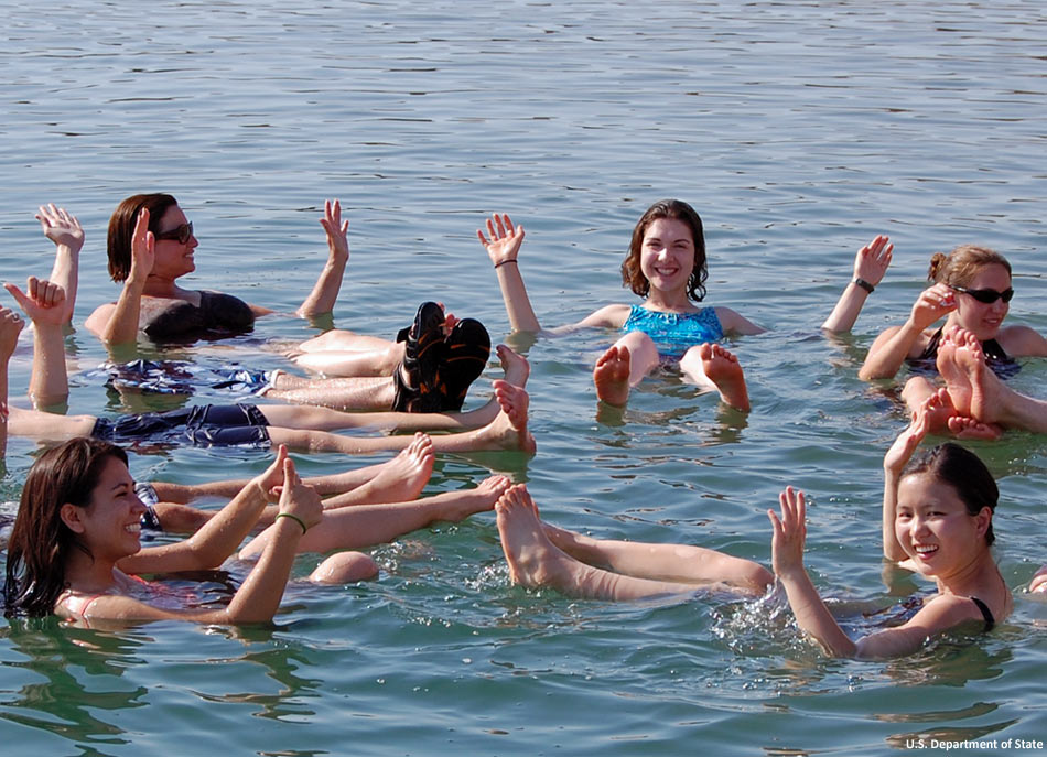 Students from Idaho enjoying the unique experience of floating in the extremely dense and salty water of the Dead Sea in the Middle East.