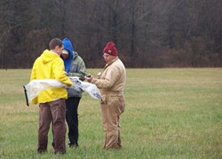  [Photo: USGS scientists working on equipment in the field.] 