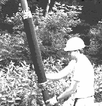  [Fig. 4 - Photo of USGS scientist with packer assembly.] 