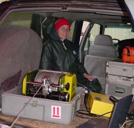  [Photo: Scientist working at winch in truck in the rain] 