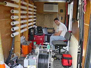  [Photo: USGS scientist operates computer in mobile field office.] 