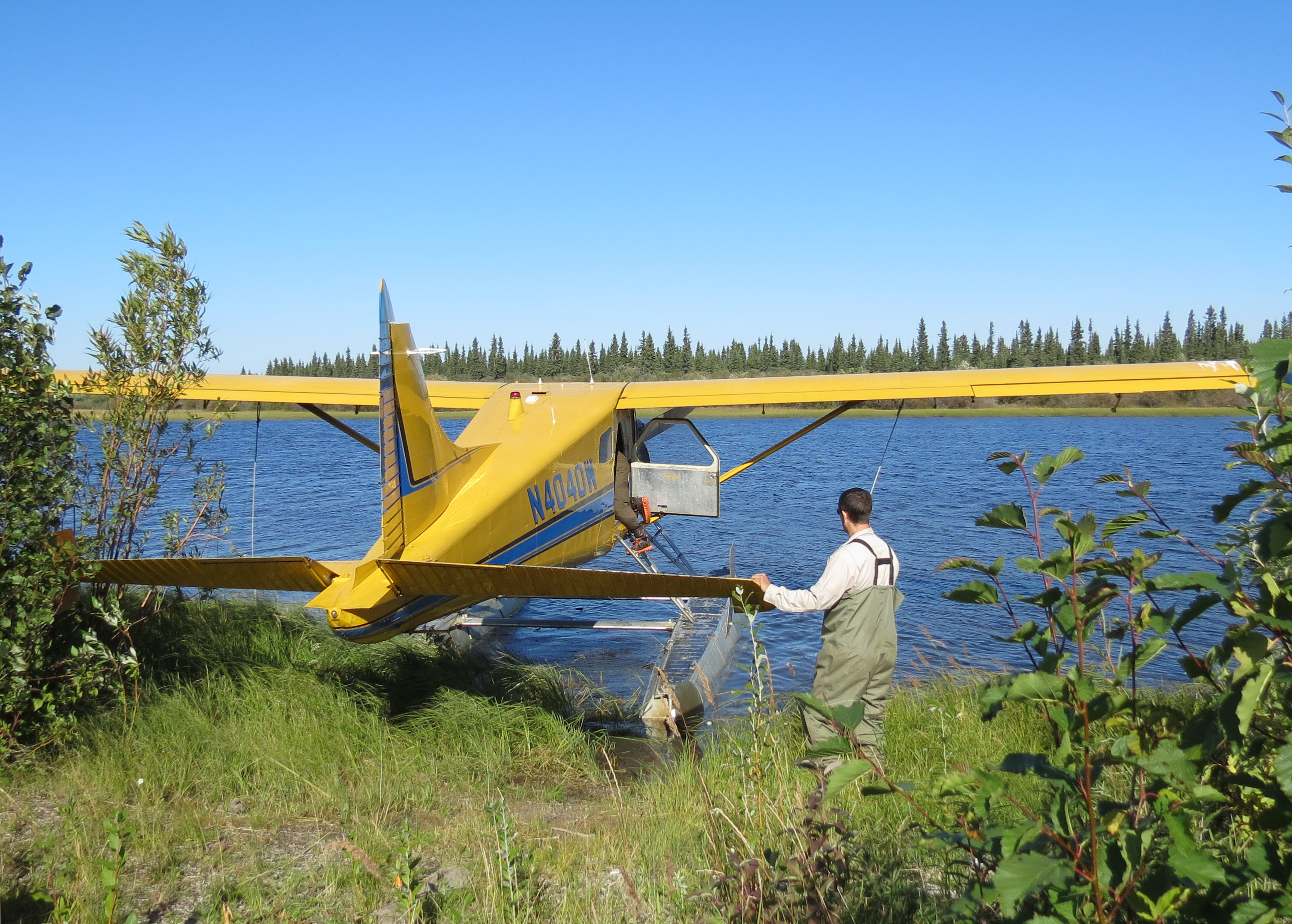 Scientist guides seaplane away from shore