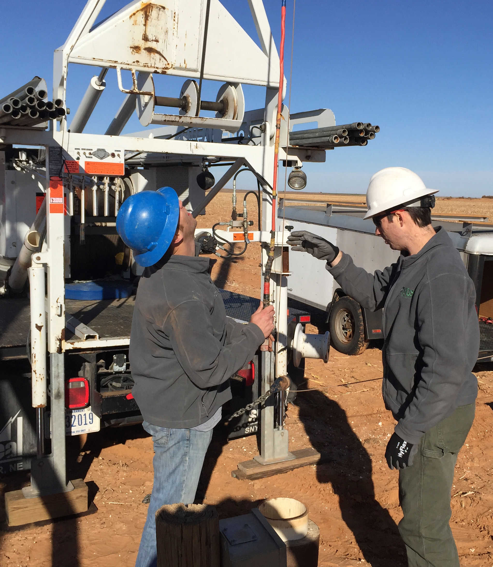  [ Photo of USGS scientists setting up equipment to log a groundwater well ]