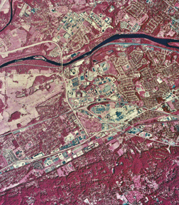 Figure 3.   This 1987 USGS National Aerial Photography Program color-infrared photograph shows the King of Prussia, Pa., area, approximately 18 miles northwest of downtown Philadelphia. The intersections of three major highways (I-76, U.S. 422, and U.S. 202), seen in the center of the picture, formed the ideal location for new commercial, retail, and industrial development within the expanding metropolitan region.