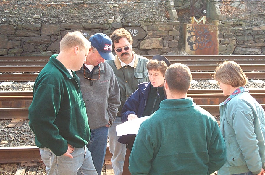 1999 Photo of Branch staff and collaborator in the field looking at field map