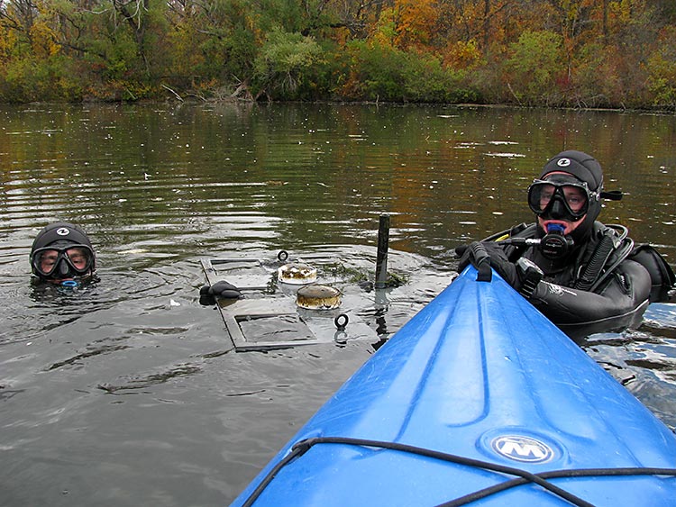 Researchers working with the Illinois Water Resources Center collect sediment core samples in Wisconsin's Whitnall Park Pond.