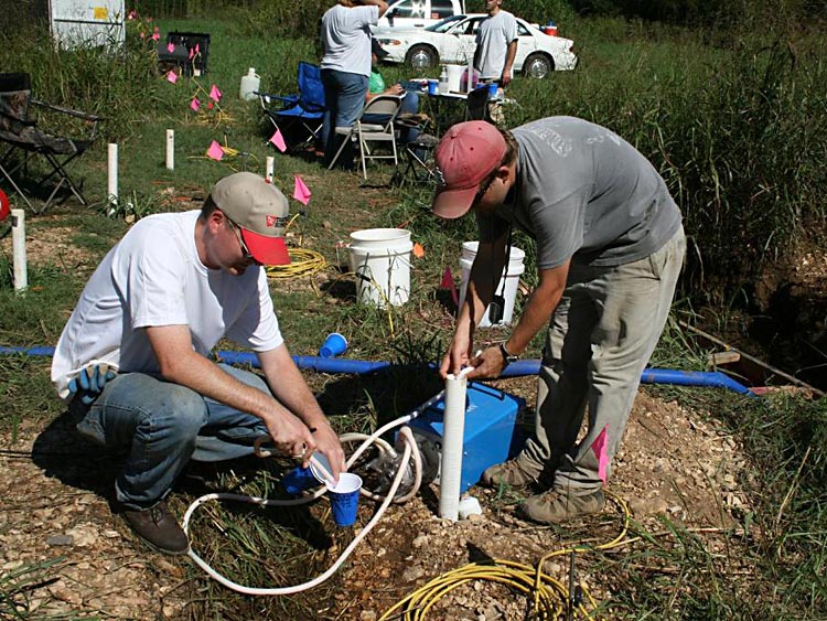 Researchers working with the Oklahoma Water Resources Research Institute sample a piezometer.